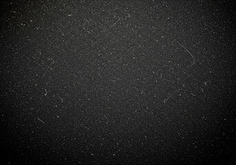 Black glitter texture with dark vignette for abstract background