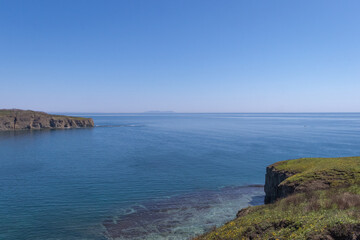 Dramatic Sea Cliffs and Clear Blue Ocean at Russky Island, Vladivostok, Russia