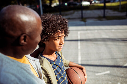 Father and son playing basketball