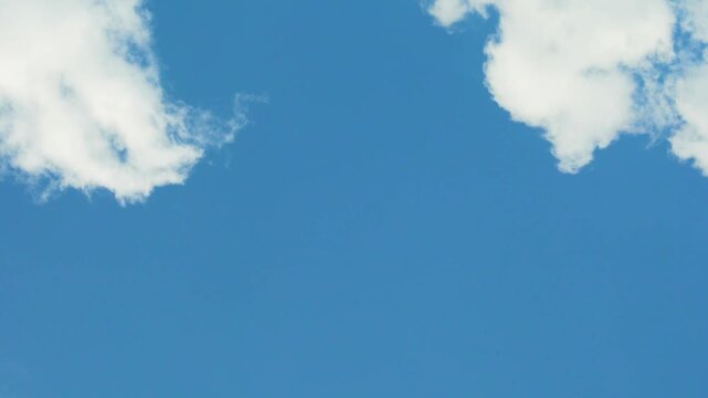 Sunny Clear Blue Sky and Few Fluffy Cotton White Clouds in Sunlight Time Lapse. Clean Pure Azure Scyscraper and Puffy White Clouds, White Cloud in Sunny Blue Sky Timelapse, Slow Motion, Atmosphere.
