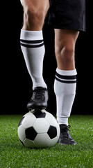 Fototapeta premium Male soccer player standing on field with ball displaying skill and control