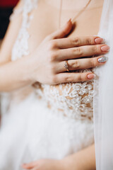 Bride’s hands with wedding rings and elegant manicure. A delicate detail shot symbolizing love, union, and beauty on the wedding day.