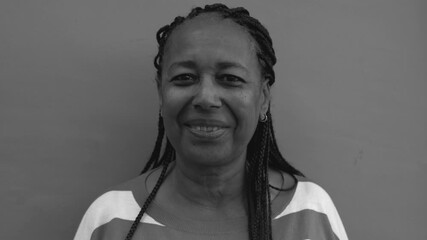 Senior african woman with braids looking on camera - Elderly black person and city lifestyle concept - Black and white editing - Powered by Adobe