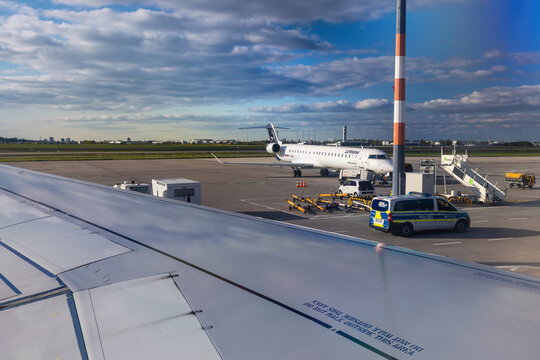 Lufthansa Airplane and Police Vehicle on the Runway, Berlin Brandenburg Airport, Germany