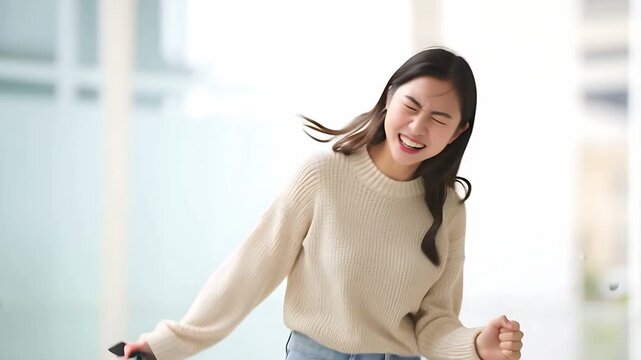 Japanese excited woman celebrating success achievement with fist pump and yelling yeah