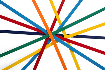 A bold and dynamic abstract photograph featuring an intricate pattern of overlapping colored plastic or paper strips