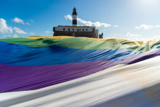 A large LGBT flag with rainbow colors is seen during a demonstration at Farol da Barra in the city of Salvador, Bahia.