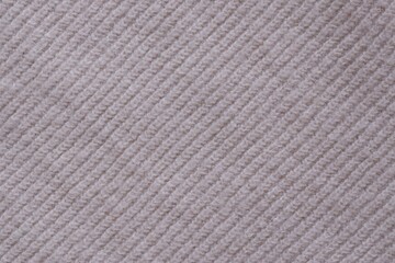 Texture of knitted pastel pink sweater, close-up texture of beige pink