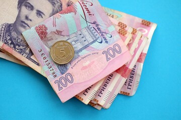 Ukrainian money bills on light blue paper background