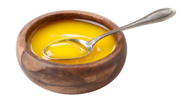 Wooden Bowl Filled with Golden Ghee and Silver Spoon clarified butter isolated on a transparent background