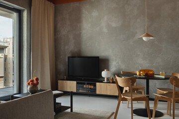 Contemporary living room with TV, wooden cabinet, round dining table and minimalist decor.