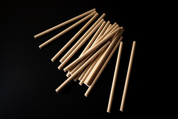 Natural wooden sticks arranged messily on a dark background showing crafting materials for various projects