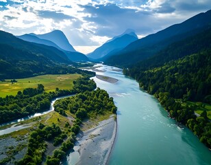Aerial view of a turquoise river winding through a lush green valley, flanked by majestic mountains under a partly cloudy sky