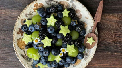 Star-shaped kiwi slices twinkle among blueberries and grapes, evoking cosmic harmony, perfect for...