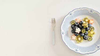 A delicate symphony of blueberries and star-shaped kiwis, evoking Hanami's floral reverie and midsummer night's culinary whimsy