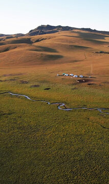 Yurts nestled in rolling Mongolian steppes, embrace Nomads' Day, echoing tranquil traces of ancient Silk Road whispers