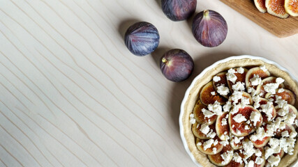 Rustic fig tart with crumbled cheese enchants autumn's harvest table, perfect for Sukkot feasts and...