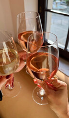 Clinking glasses sparkle with rose wine, a symphony of camaraderie, bubbly effervescence celebrating Bacchanalia, Galentines toast ritual