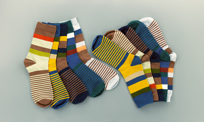 Striped men's socks on a gray background. Men's socks are fanned out.