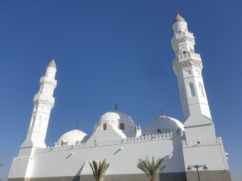 Aerial view of Masjid Quba at outdoor with blurred background. Street photography concept design. Islamic praying building at Middle East. Madinah city, Saudi Arabia.
