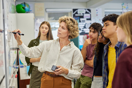 High school teacher giving lesson to multiethnic students