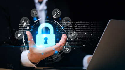 Concept of cybersecurity and data protection with glowing lock icon in businessman hand,...