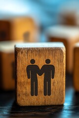 Closeup shot of a single wooden block with empathy icon two figures embracing inside a heart