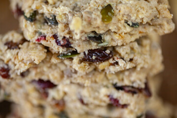 Stacked healthy oatmeal flapjacks, oatbars on rustic wooden chopping board