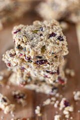 Stacked healthy oatmeal flapjacks, oatbars on rustic wooden chopping board