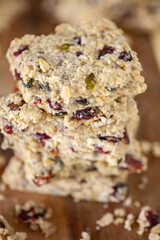 Stacked healthy oatmeal flapjacks, oatbars on rustic wooden chopping board