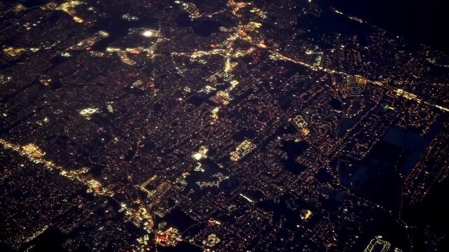 Airplane flying over New York City Skyline illuminated at night. Airplane Jet plane taking off from New York airport at night