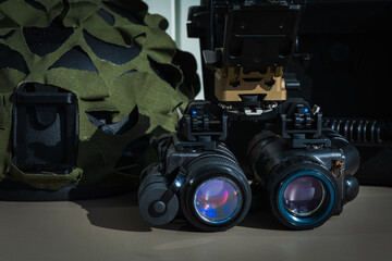 Close-up of modern night vision goggles (NVG) and a combat helmet, professional equipment for military special forces operations.