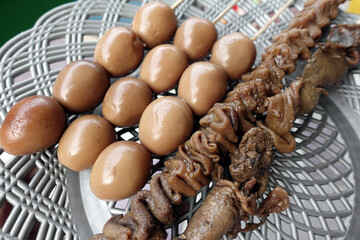 Assorted Skewered Meat and Quail Satay on Grilled Tray Displaying Savory Street Food. Traditional food
