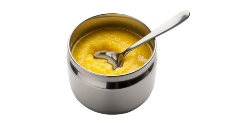 Pure ghee stored in a steel container with a silver spoon ready for use