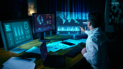 Analyst interacting with digital world map and futuristic data screens. Concept of data analytics, AI, cybersecurity, fintech analysis, and interface overload in modern tech environments. Collage