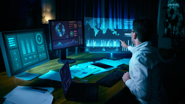 Analyst interacting with digital world map and futuristic data screens. Concept of data analytics, AI, cybersecurity, fintech analysis, and interface overload in modern tech environments. Collage