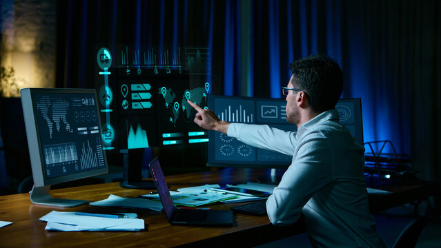 Analyst pointing at digital logistics data screens in modern workspace. Concept of AI automation, fintech trading, cybersecurity monitoring, digital fatigue, and modern UX overload. Collage