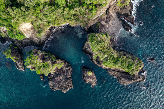 Aerial view of rocky islands surrounded by turquoise ocean and lush greenery. Paya, on We Island in Aceh, Sumatra, Indonesia
