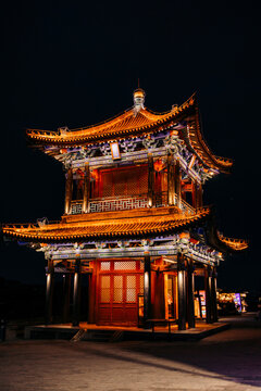 Illuminated traditional Chinese pagoda at night with intricate details and warm lights. Xi'an, China
