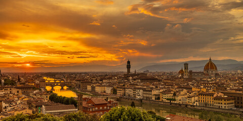 Stunning sunset over Florence with the Arno River and iconic cathedral silhouetted. Florence, Italy