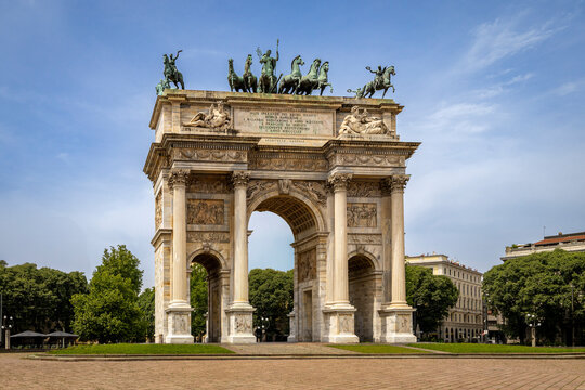 Historic Arco della Pace Arch in Milan with detailed sculptures on top against a clear blue sky. Italy