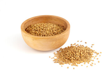 Fenugreek seeds in wooden bowl on white background