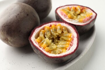 Fresh passion fruits on white table, closeup