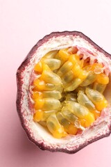 Half of fresh passion fruit on pink background, closeup