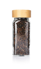 Peppercorns in glass jar isolated on white. Aromatic spice