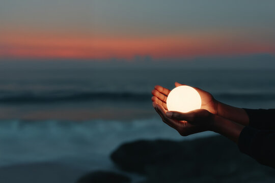 Hands Holding Glowing Globe of Fragile World
