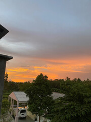Colorful Sunset Sky with Tropical Trees and Rural Houses