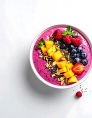 Vibrant pink smoothie bowl with fresh berries, mango, chia seeds, and granola on a clean white background, perfect for a healthy breakfast