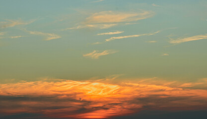 Enchanted sky glows  behind soft gentle clouds