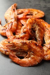 Tasty grilled shrimps on grey table, closeup. Delicious seafood dish
